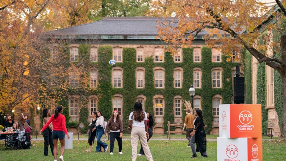 Students on a lawn playing ball.