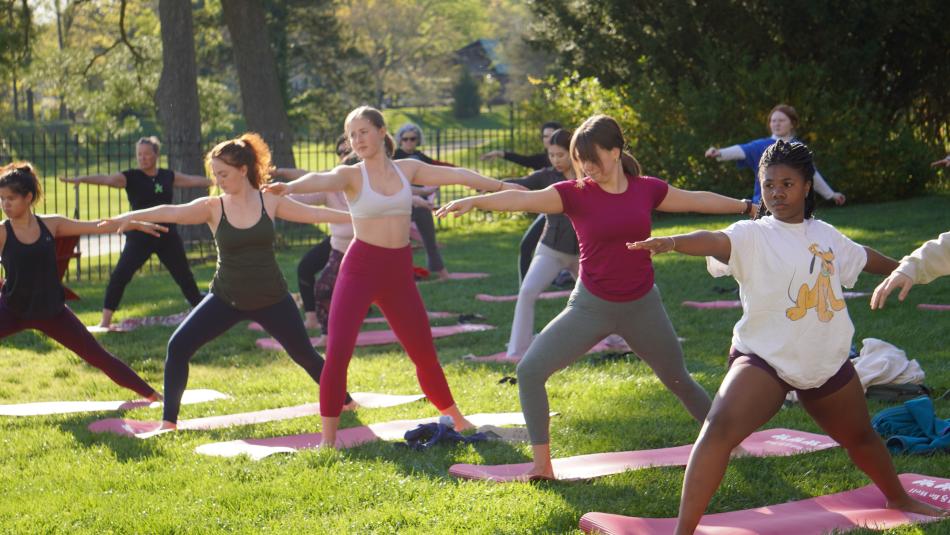 Students practicing yoga outdoors
