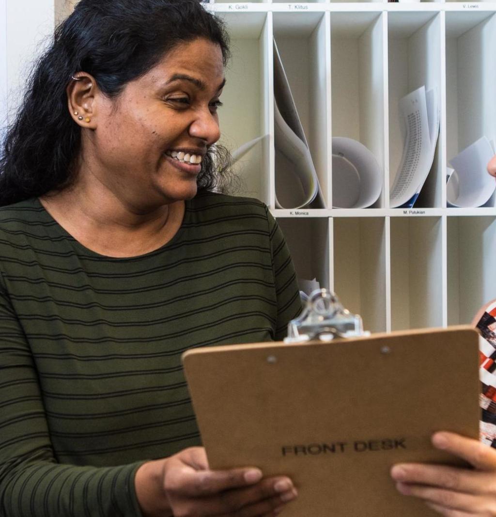 Two women reviewing a clipboard 