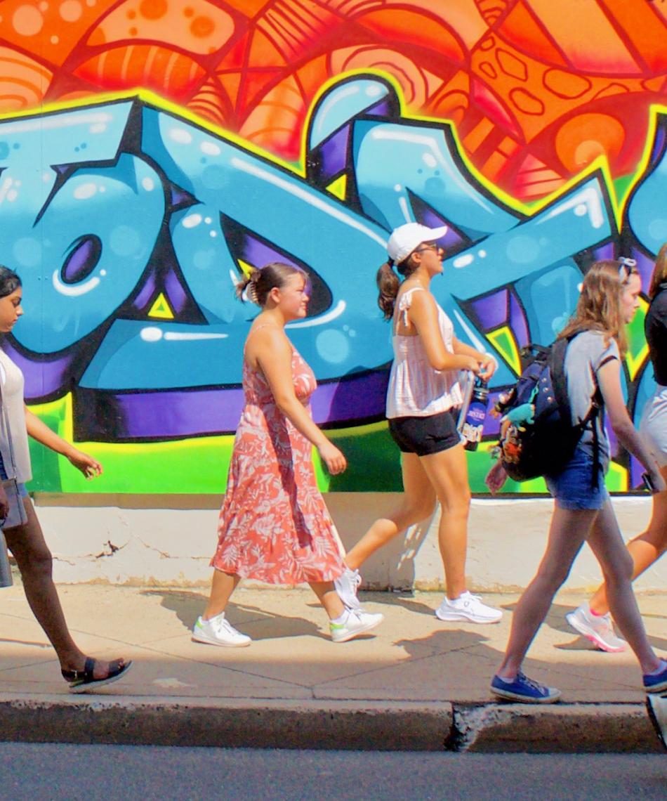 Students in front of a mural