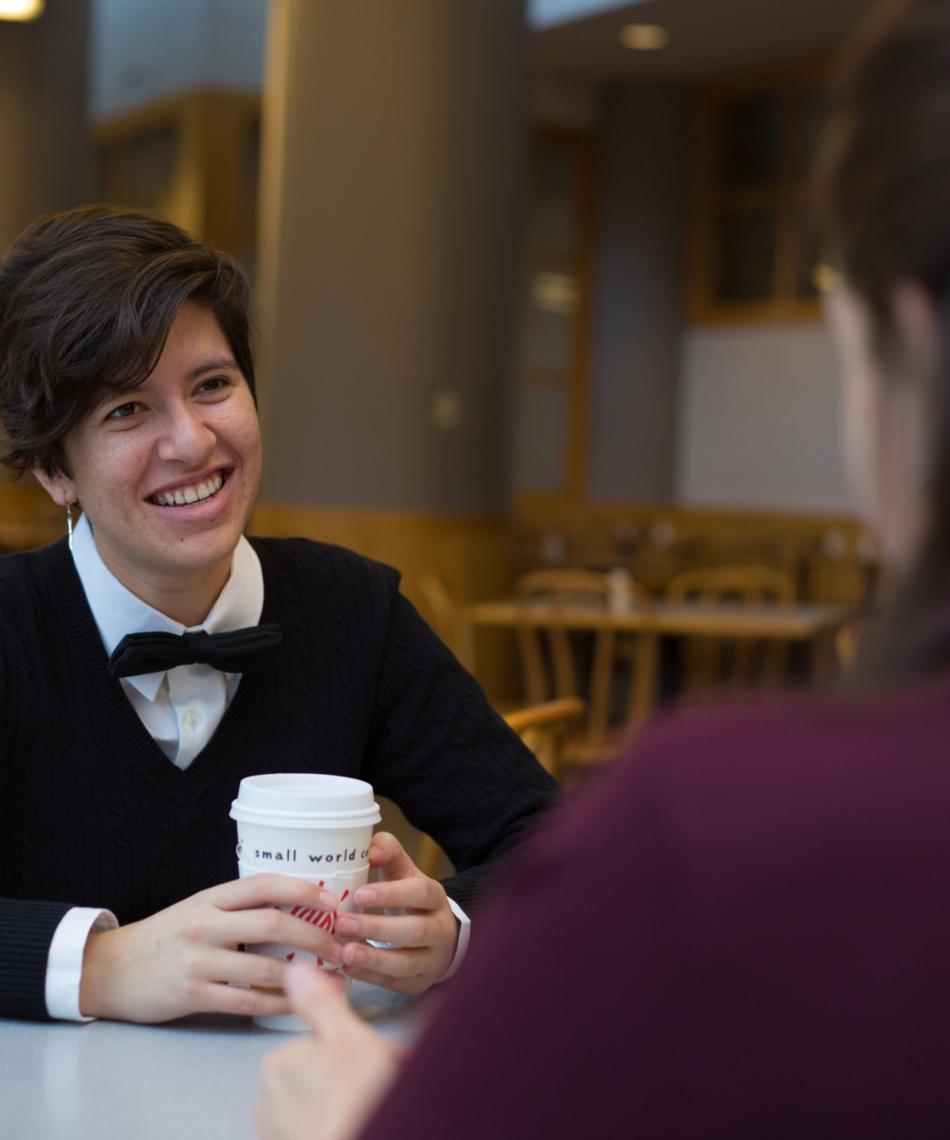 Person smiling with coffee