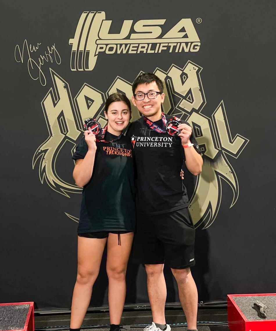 Students posing with a medal