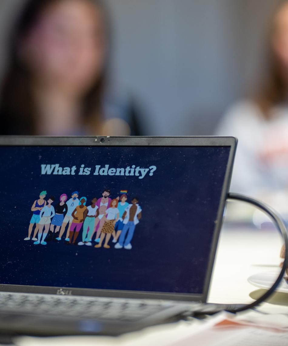 Laptop displaying question "what is identity?"