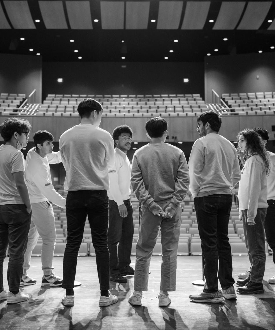 Students standing on a stage 