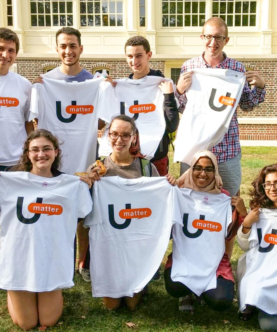 Students holding up a UMatter shirt