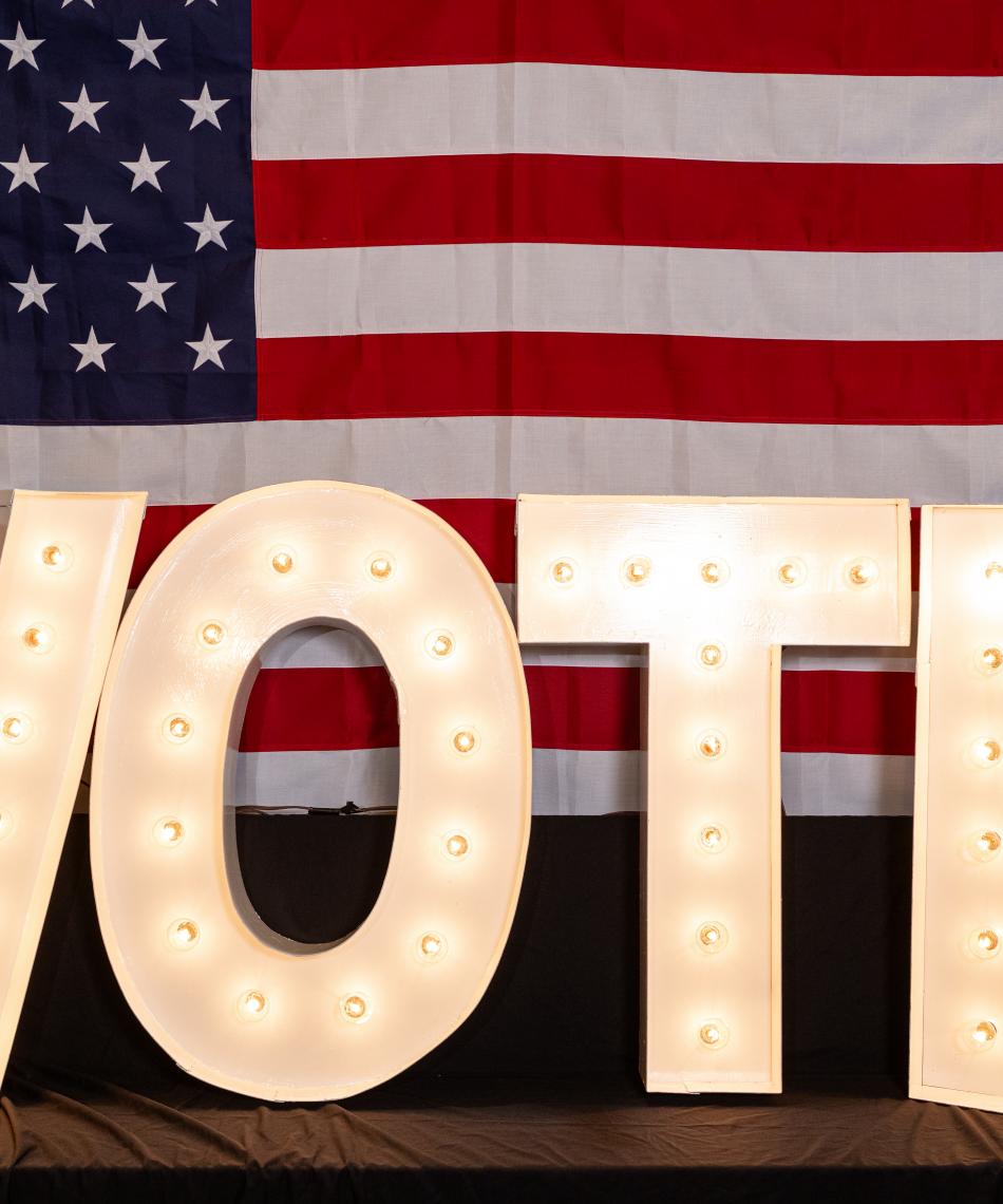 VOTE letters in front of an American flag