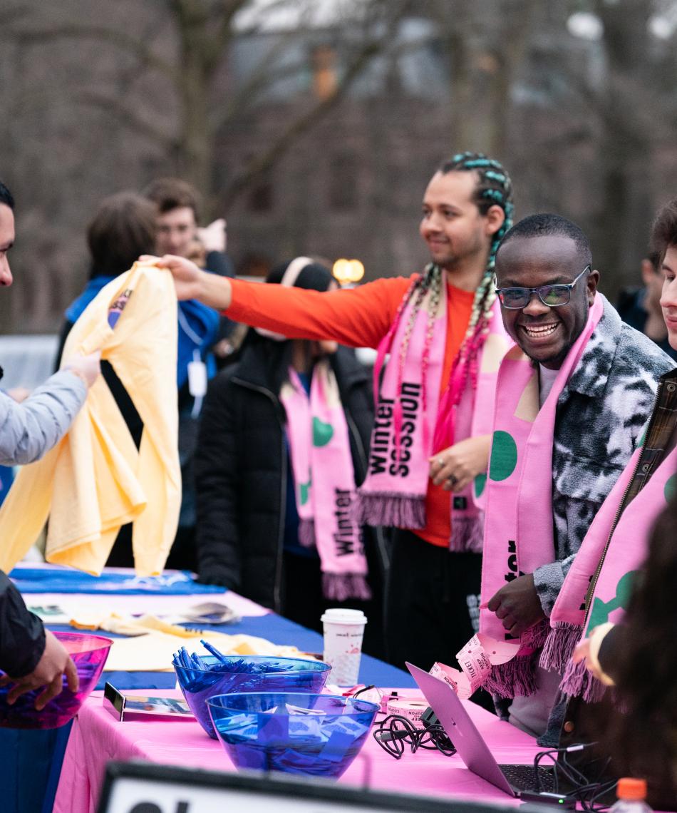 Students giving out Wintersession gear 
