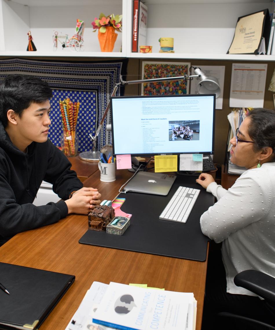 student chatting with staff