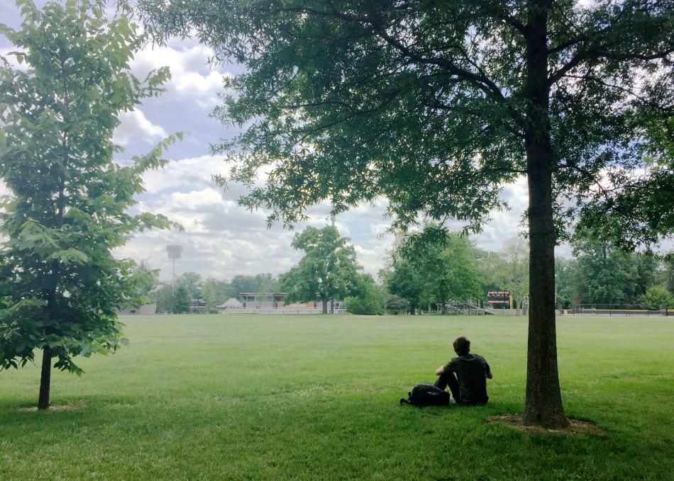 Student relaxing on Poe Field