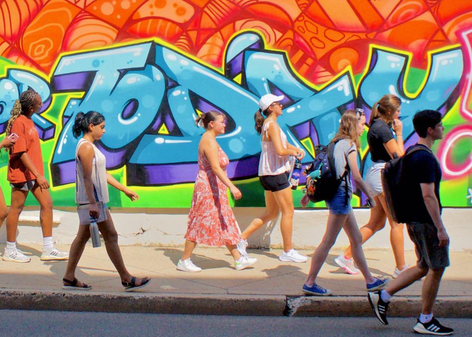 Students in front of a mural
