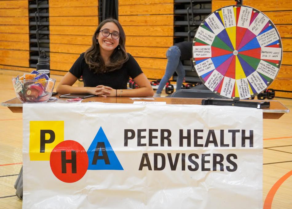 A peer health adviser at a student fair