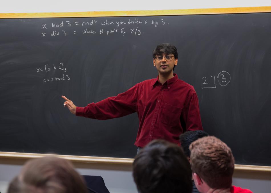 Teacher standing in front of a chalkboard 