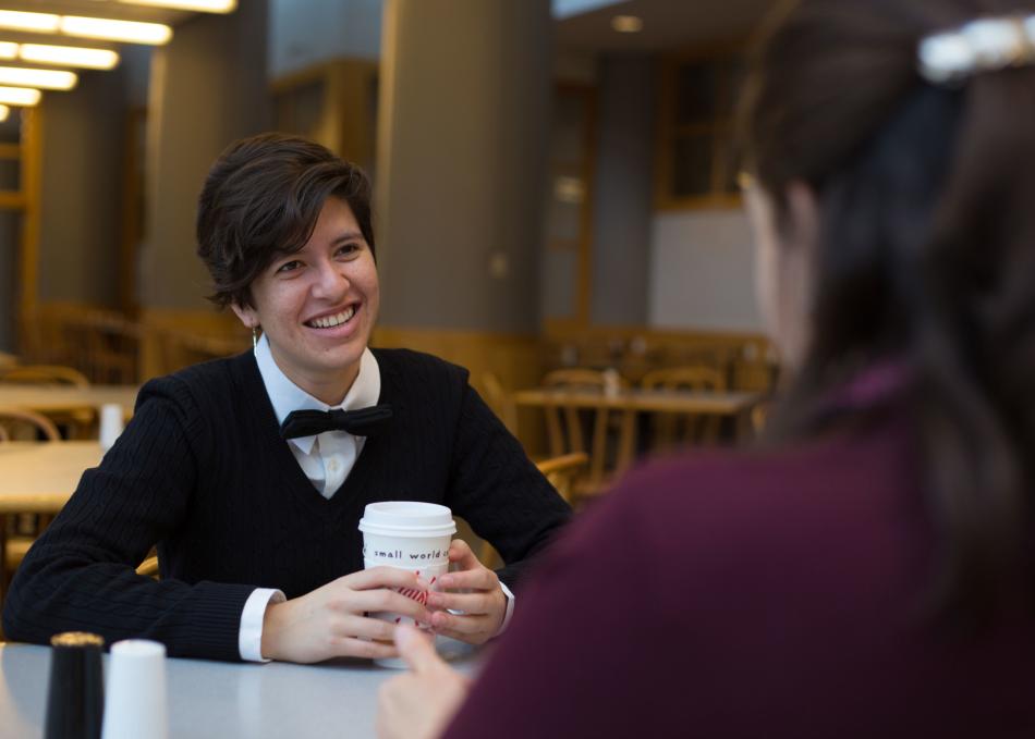 Person smiling with coffee