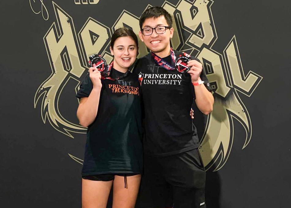 Students posing with a medal