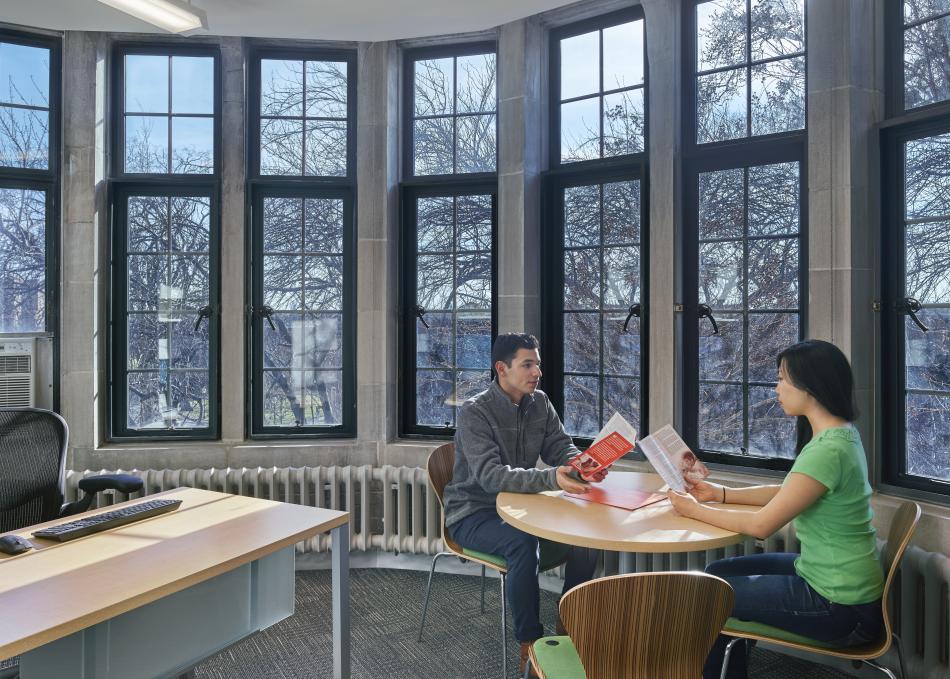 Students looking at a pamphlet 
