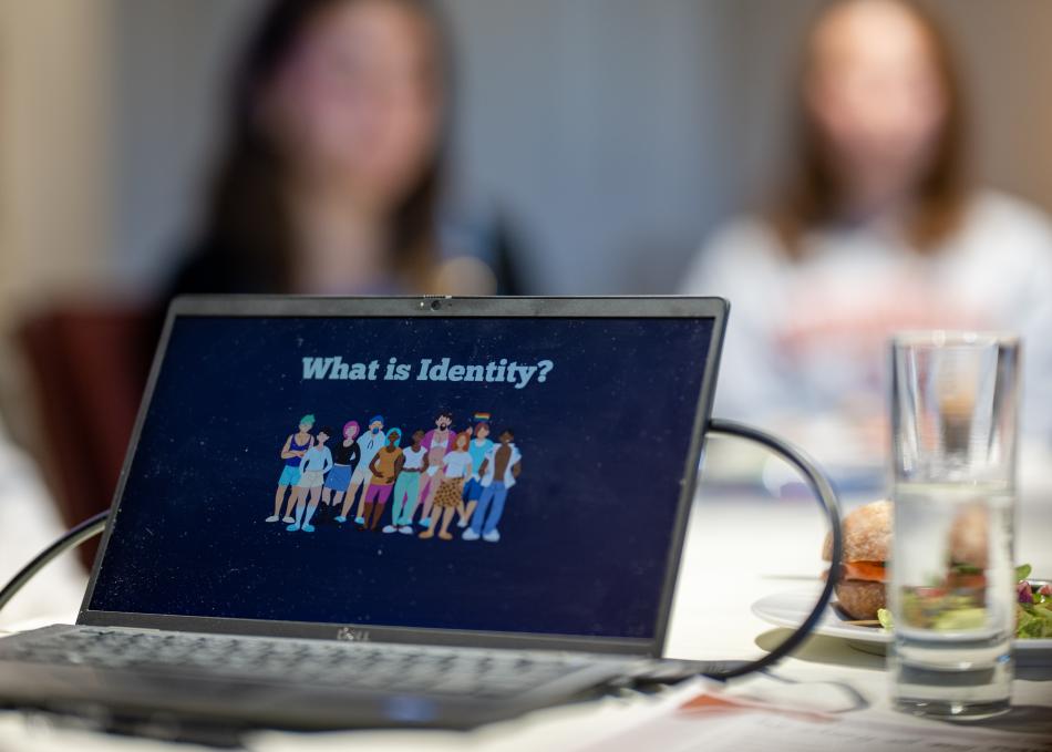 Laptop displaying question "what is identity?"