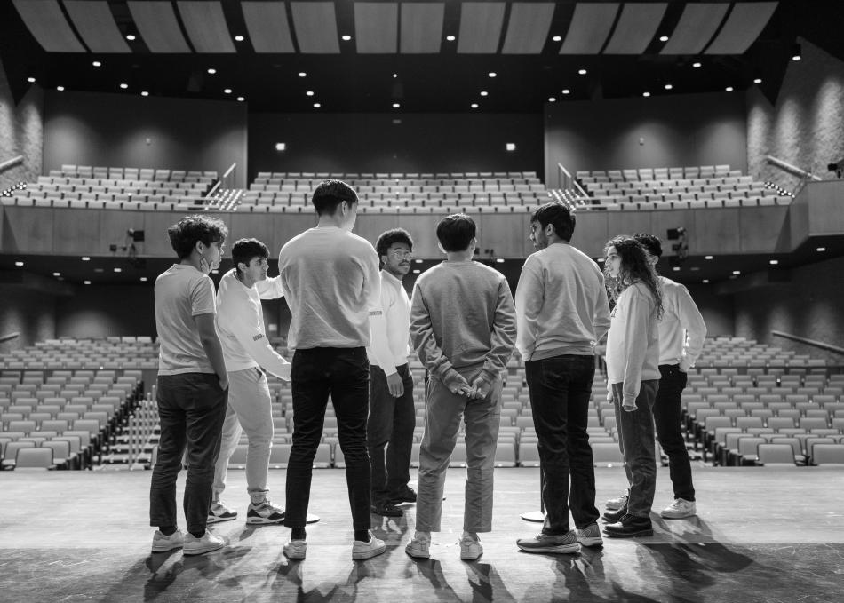 Students standing on a stage 