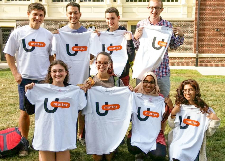 Students holding up a UMatter shirt