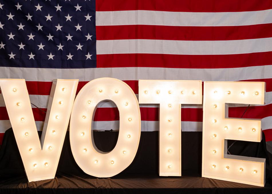 VOTE letters in front of an American flag