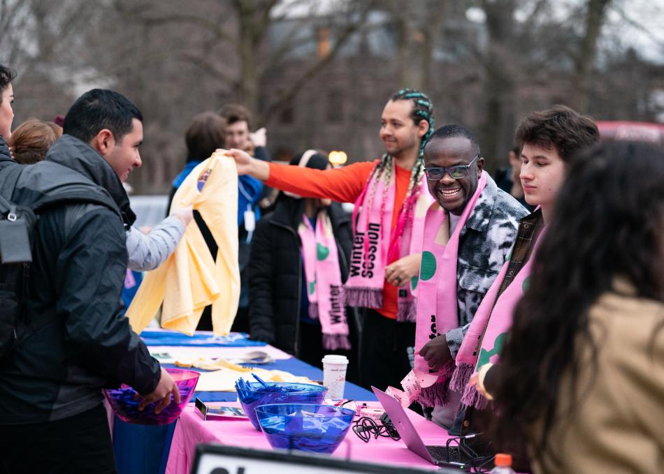 Students giving out Wintersession gear 