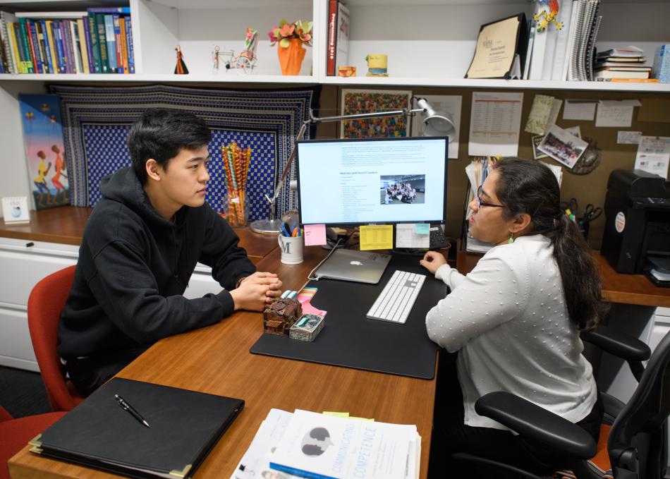 student chatting with staff