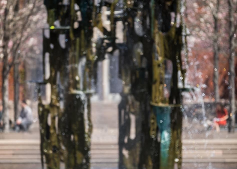Student relaxing by a fountain