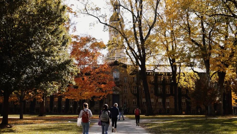 Students walk through campus on a beautiful fall day.
